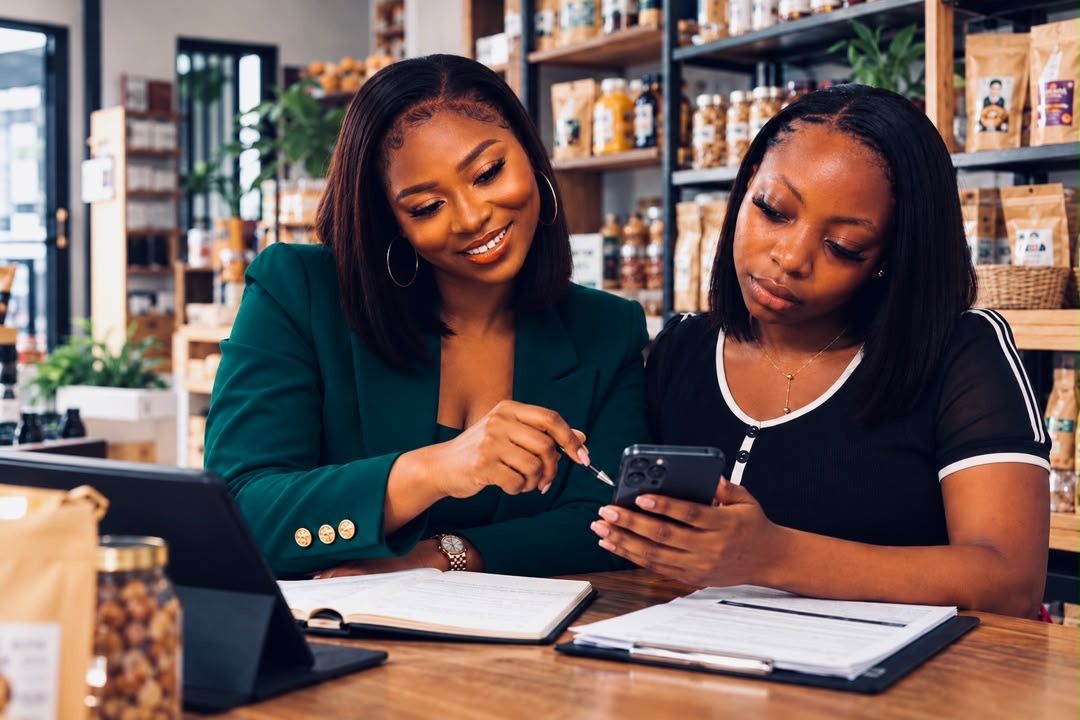 A SAKI SE adviser going through records with a business owner