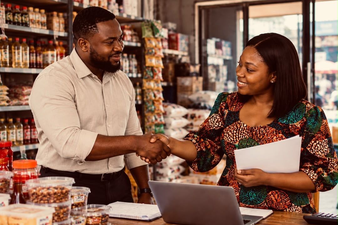 A supplier and a shop owner shaking hands on an agreement