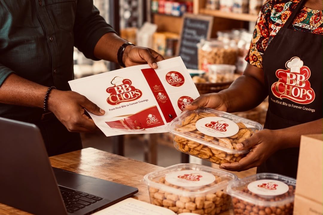 A designer showing printed labels to a snack maker